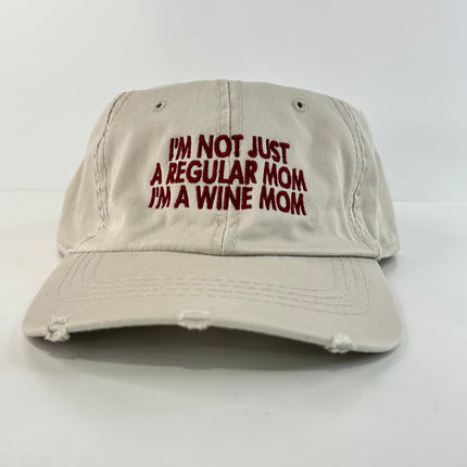 I’m not just a regular mom I’m a wine mom on a tan Strapback hat cap Collab cut the activist custom embroidery