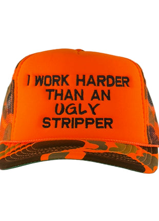 Orange and camouflage cap with text 'I Work Harder Than An Ugly Stripper' on a gray background