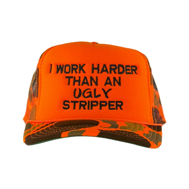 Orange and camouflage cap with text 'I Work Harder Than An Ugly Stripper' on a gray background