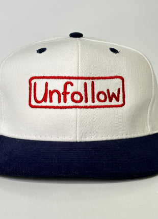 Unfollow on a white and navy Strapback hat cap Custom Embroidery