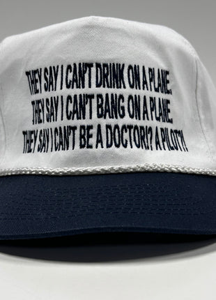 They say I can’t drink on a plane they say I can’t bang on a plane on a white crown navy brim SnapBack hat cap custom embroidered