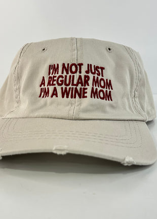 I’m not just a regular mom I’m a wine mom on a tan Strapback hat cap Collab cut the activist custom embroidery